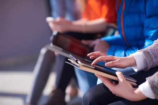 students group working on school  project  together on tablet computer  at modern university